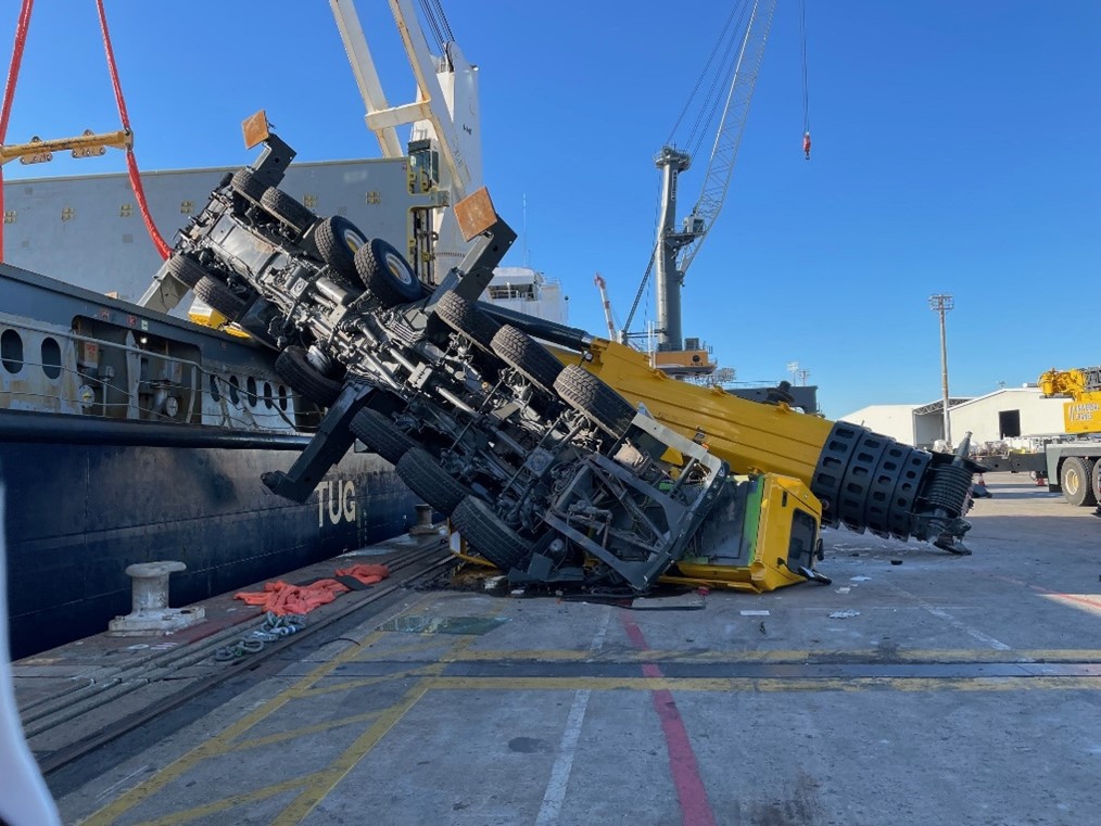 Crane dropped on ship and wharf